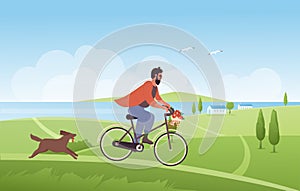 Man cycling in summer nature landscape, riding bicycle with flowers in basket, dog runs