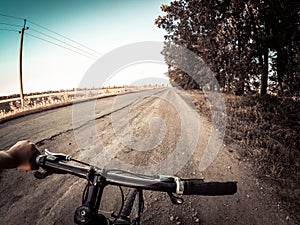 A man cyclist holds a bicycle behind the wheel