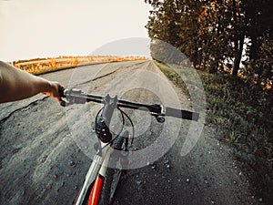 A man cyclist holds a bicycle behind the wheel