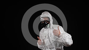 A man dances in a chemical protection suit with a respirator and goggles