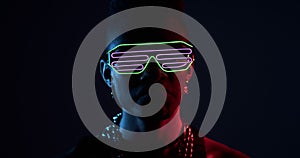 Man dancing with glowing glasses and chain necklace