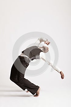 Man Dancing Jazz Over White Background photo
