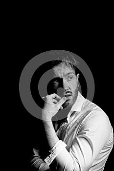 A man on a dark background. With furrowed brows.With thoughts of a difficult future.