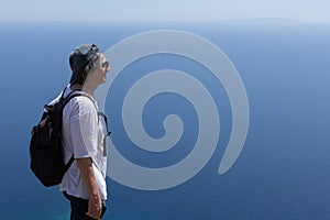 a man in dark glasses looks into the sea distance. Greece, Crete
