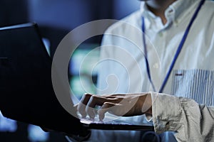 Man in data center with laptop, close up