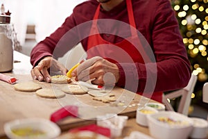 Man decorating cookies in the kitchen