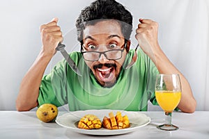 A man is delighted to see mouthwatering mango desert.