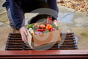 Man Delivering Box Of Fresh Ingredients For Online Meal Food Recipe Kit To Home On Doorstep