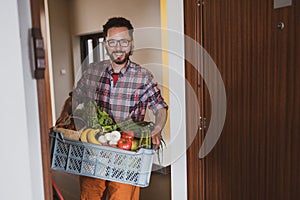 Man delivering fruit and vegetable box photo