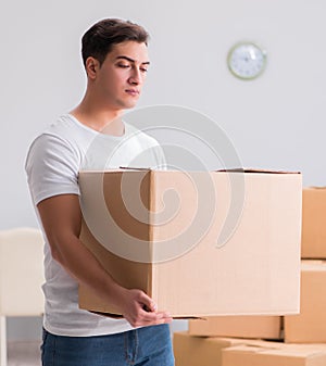 Man delivering heavy boxes at home