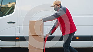 Man delivering packages. Pushing cardboard boxes on the troley