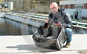 Man demonstrating freshly caught fish