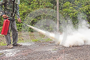 A man demonstrating how to use a fire extinguisher photo