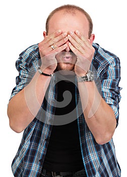 Man in denial covering eyes