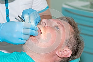 Man in dentist office doing annual check up