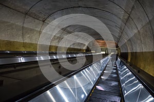 Man descending escalator into the Washington DC Metro