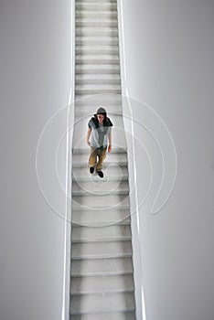 Man descending staircase in white cube gallery