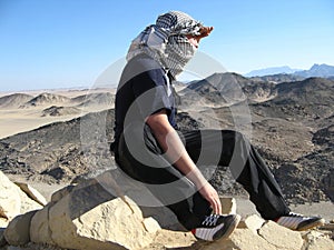 Man in desert with keffiyeh