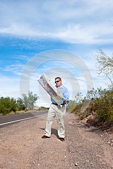 Man on deserted road reading map photo