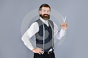 Man designing for men. successful sartor ready to work. formal and office style. man tailor with tape measure and photo
