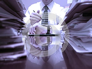 Man at Desk with Files Pointing at Watch Clock