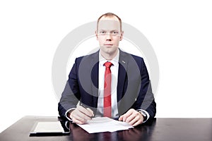 The man at the desk before signing the contract. Looks forward.