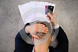 Man in desperation with credit card debt photo