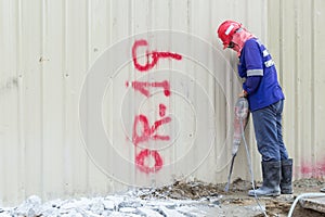 A man destroy concrete of floor