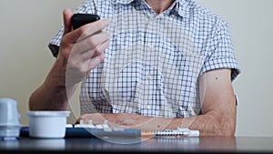 Man with diabetes perform the scan of the reader over the sensor