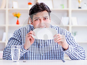 Man on diet waiting for food in restaurant