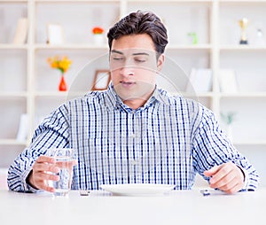 Man on diet waiting for food in restaurant