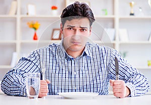 Man on diet waiting for food in restaurant