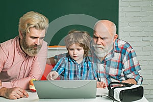 Man in different looking at laptop screen, social network. Old grandfather father and son using notebook. Male Multi