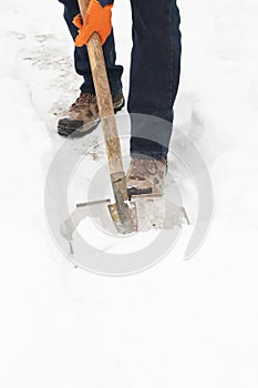 Man digging a path from snow