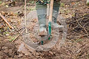 Man digging with spade in garden