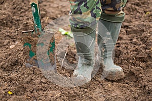 Man digging with spade in garden