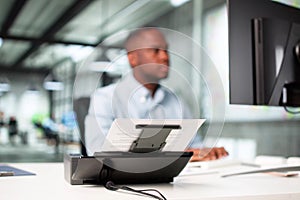 Man Digitizing Paper Documents Using Scanner