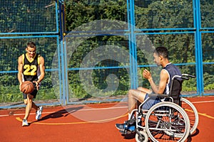 Man with disability playing basketball with friend at sports court.