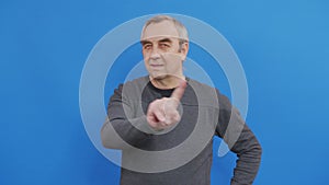 Man disapproving with no finger sign make negation gesture. Denying, Rejecting, Disagree, Portrait of men on blue