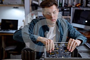 man disassembles broken computer. Computer service and repair concept. Computer disassembling