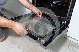 Cleaning a dirty oven in the kitchen