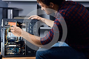 Man disassembling and reassemblin the computer