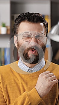 Man disgust, abomination, FU, auch emotion. Vertical view of bearded male teacher or businessman with glasses looking at