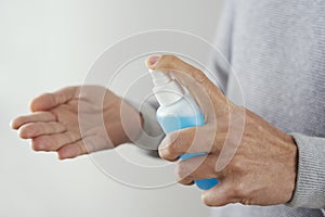 Man disinfecting his hands with hand sanitizer