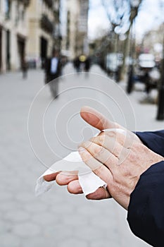 Man disinfecting his hands with a wet wipe