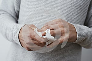 Man disinfecting his hands with a wet wipe