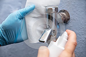 Man disinfecting the lavatory flush or toilet flushing in days of the corona pandemic, hygienic