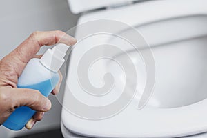 Man disinfecting the toilet seat