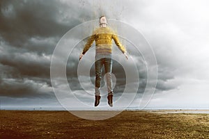 Floating man with disintegration effect photo