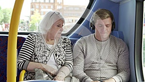 Man Disturbing Passengers On Bus Journey With Loud Music